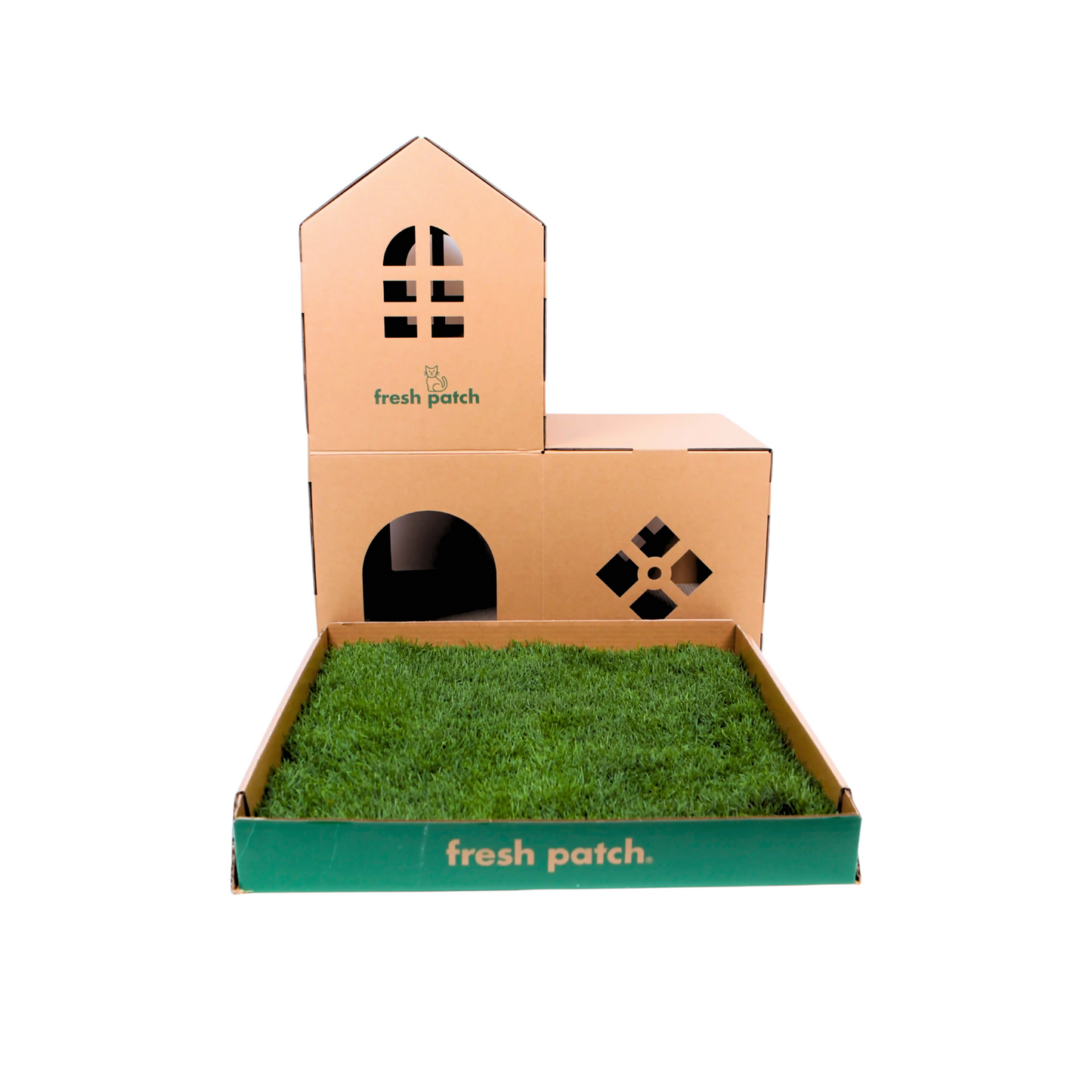 Carboard cat house with grass patch in a cardboard box sitting in front