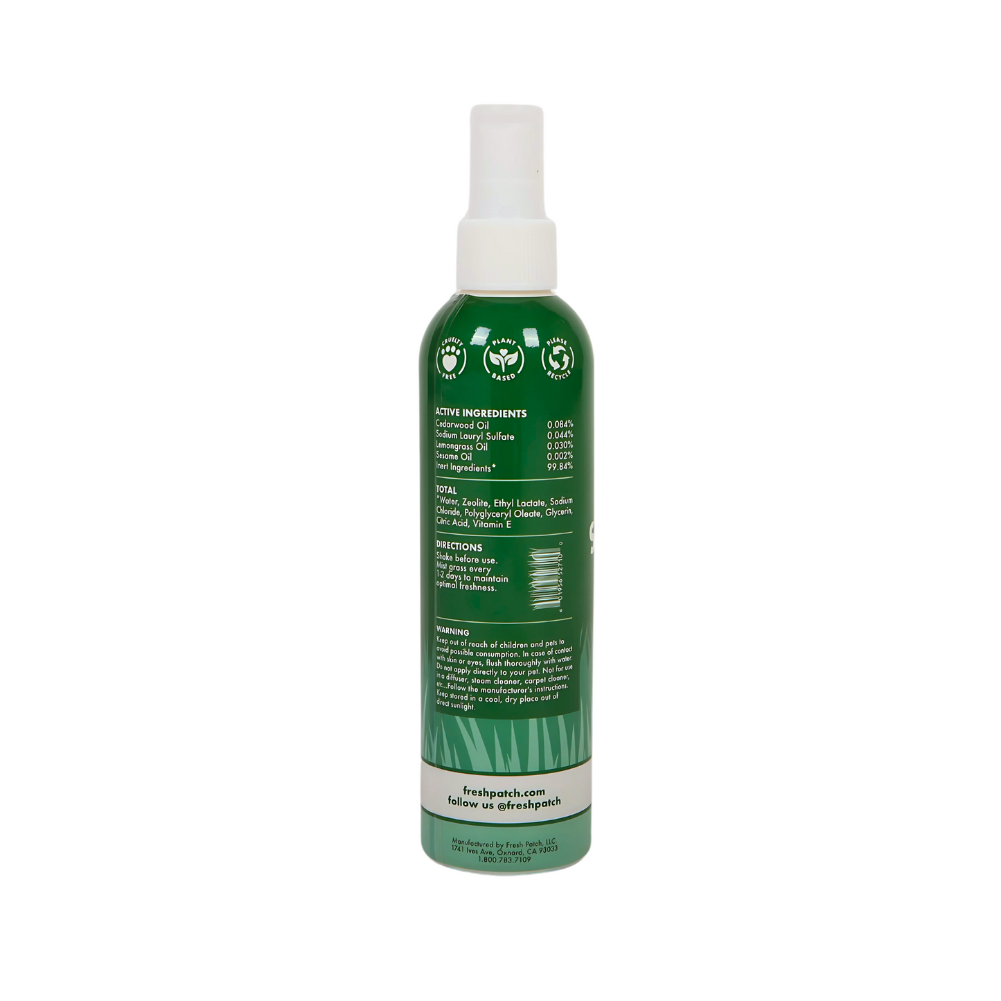 Green spray bottle with a label on a white background