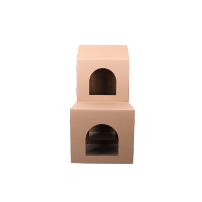 Two-tiered cardboard pet house on a white background