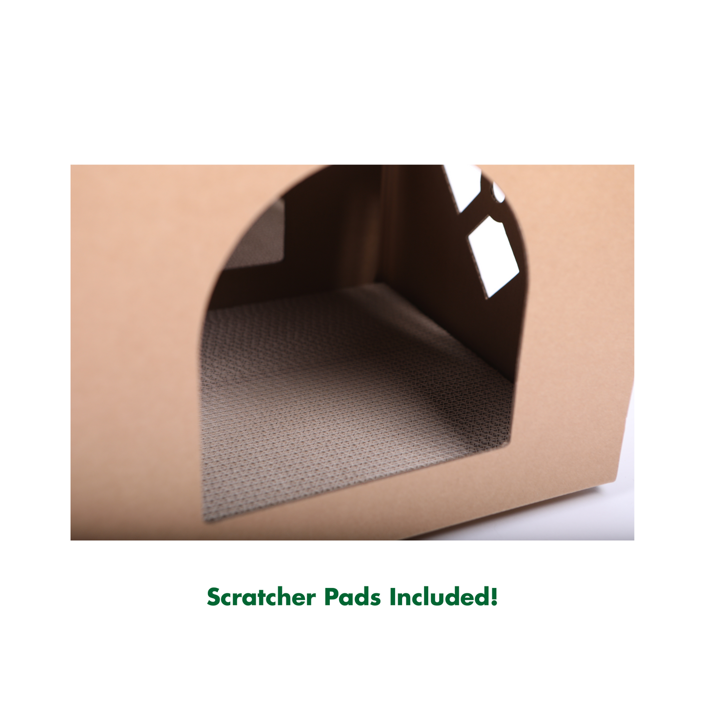 Cose-up of cardboard cat house with a textured interior and text 'Scratcher Pads Included!' at the bottom.