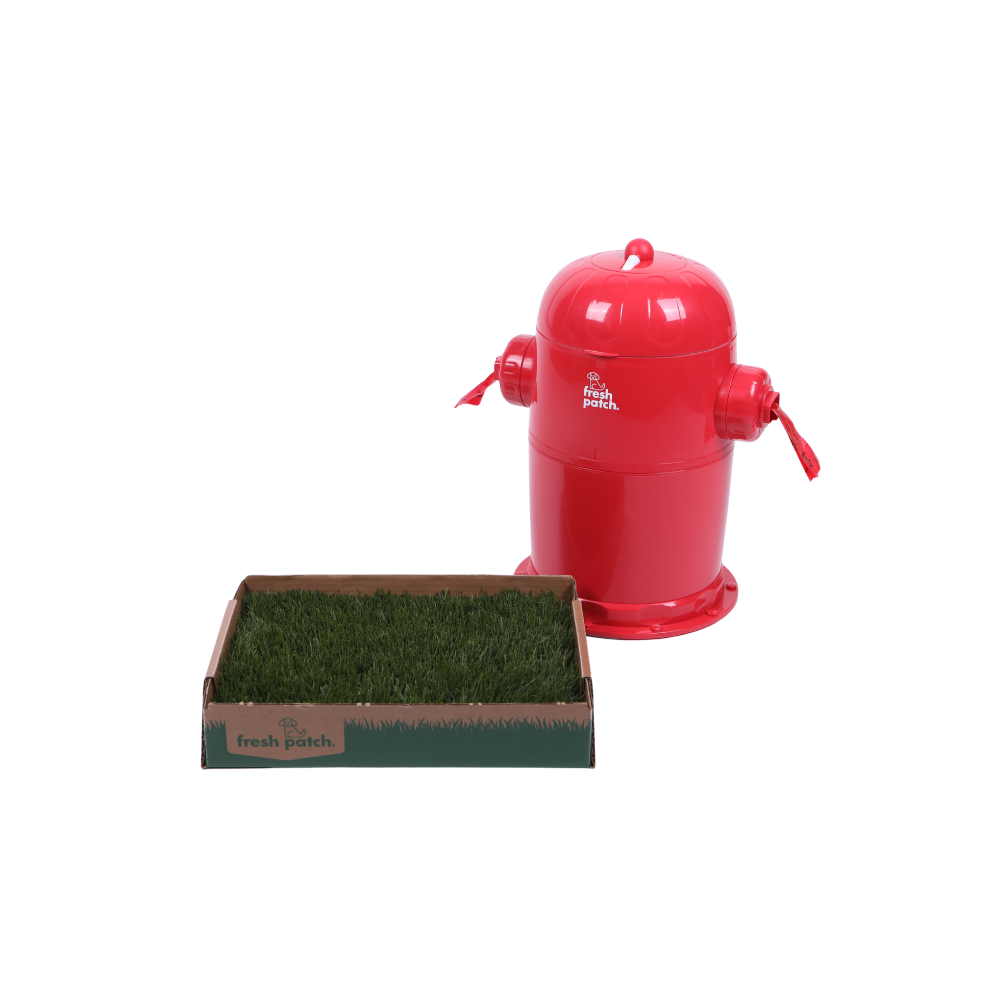 Fresh Patch fire hydrant-style outdoor trash can with a red dome-shaped body and side nozzles, shown next to a rectangular tray filled with green real grass on a white background.