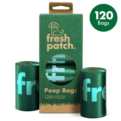 Green packaging of fresh patch poop bags with two rolls on a white background