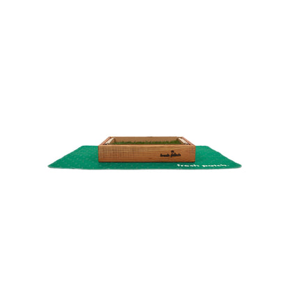 Green pad with a grass patch with a wooden border on a white background
